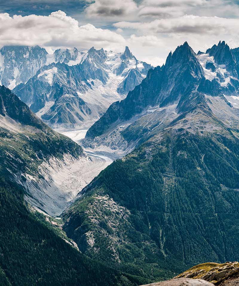 Mountains with snow and a cloudy backdrop.