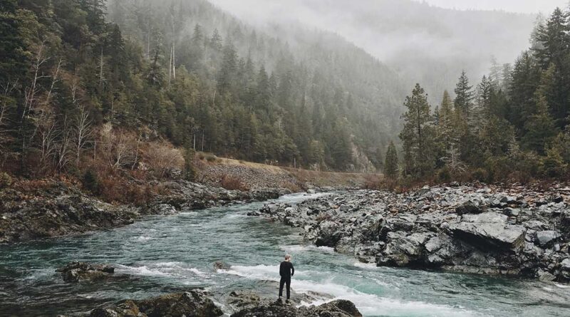 man by river in cloudy valley nature quotes