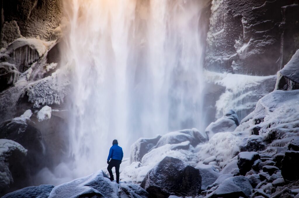 Man in front of waterfall