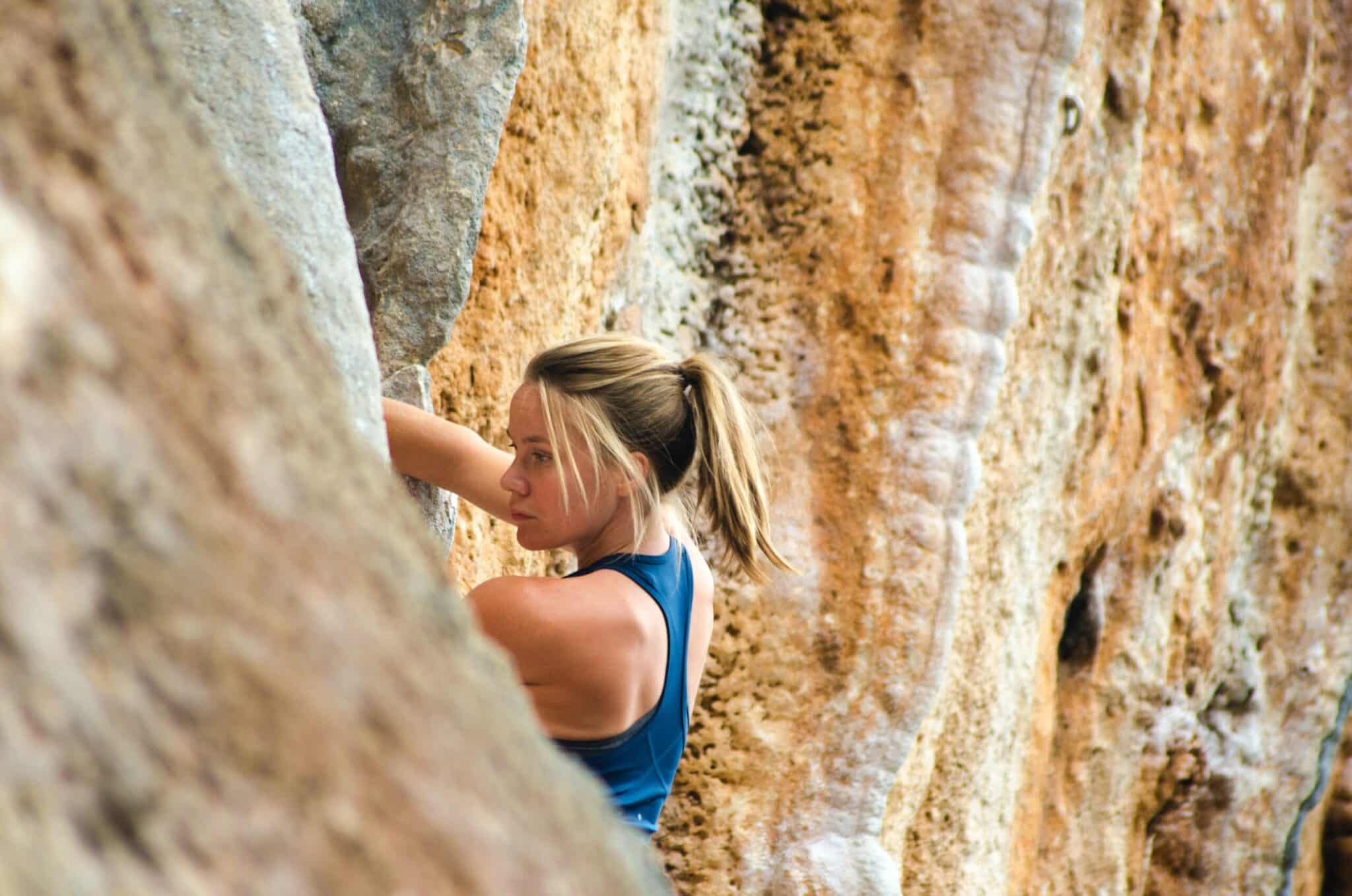 Woman climbing rockface