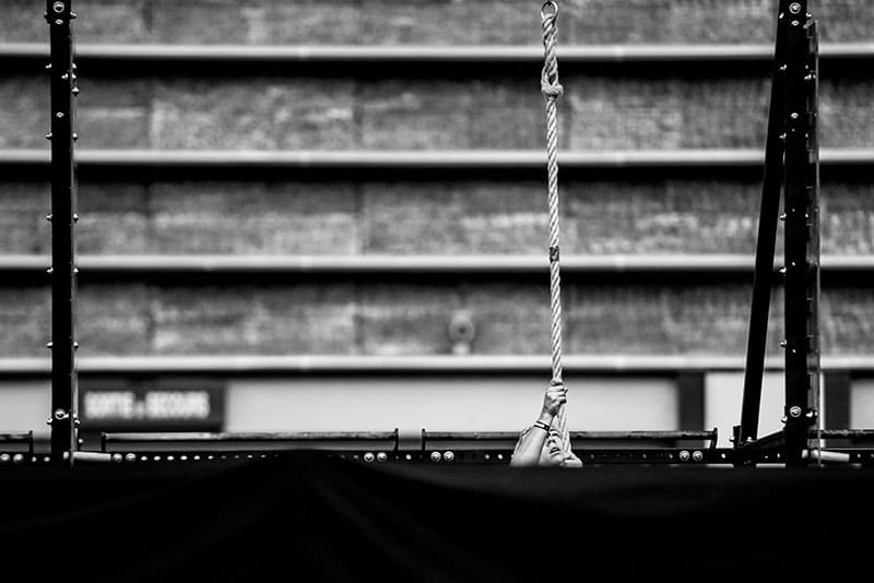 Athlete climbing rope