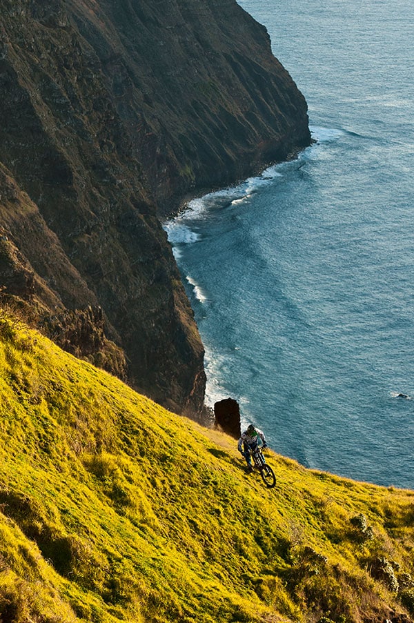 mountain biker on cliff next to the sea