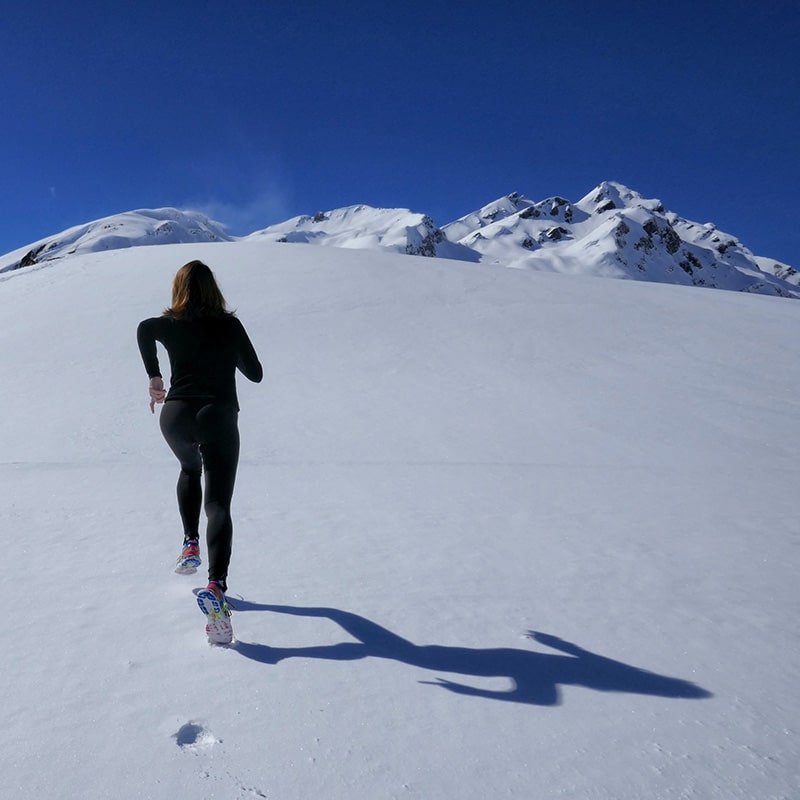 woman running in the snow