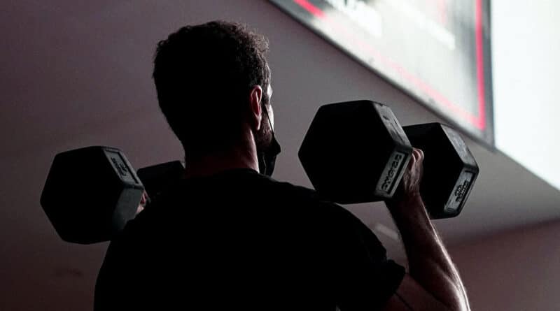 Dumbbell Thruster performed by man