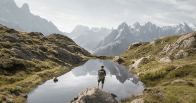 Man outdoors in mountains next to lake adventure