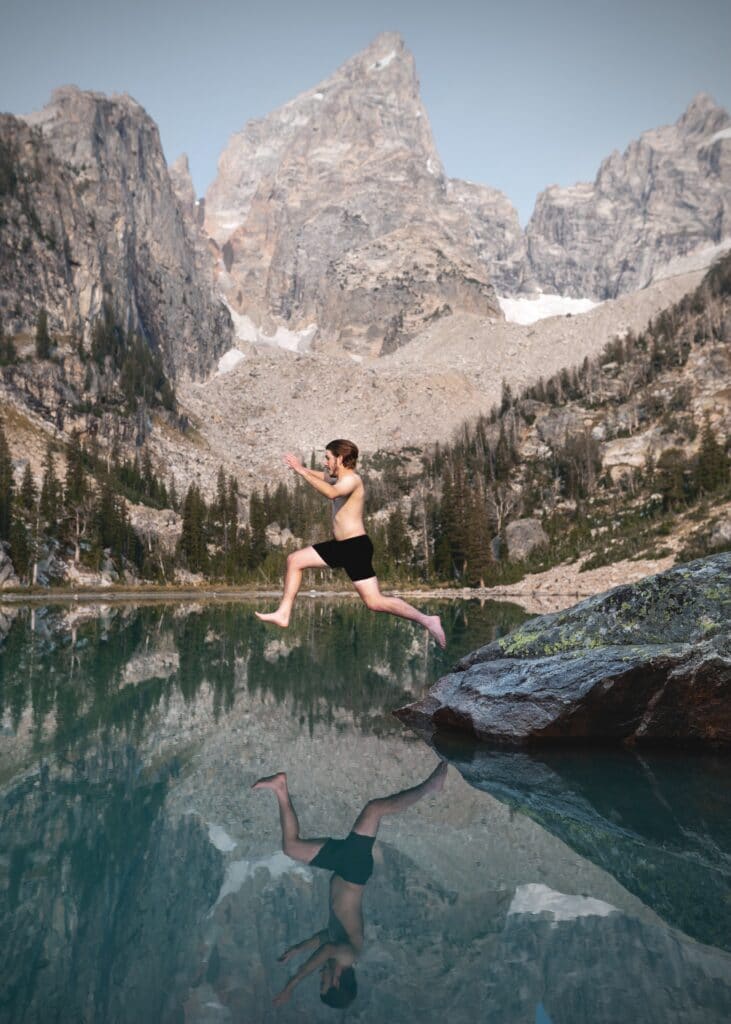 man jumping into lake