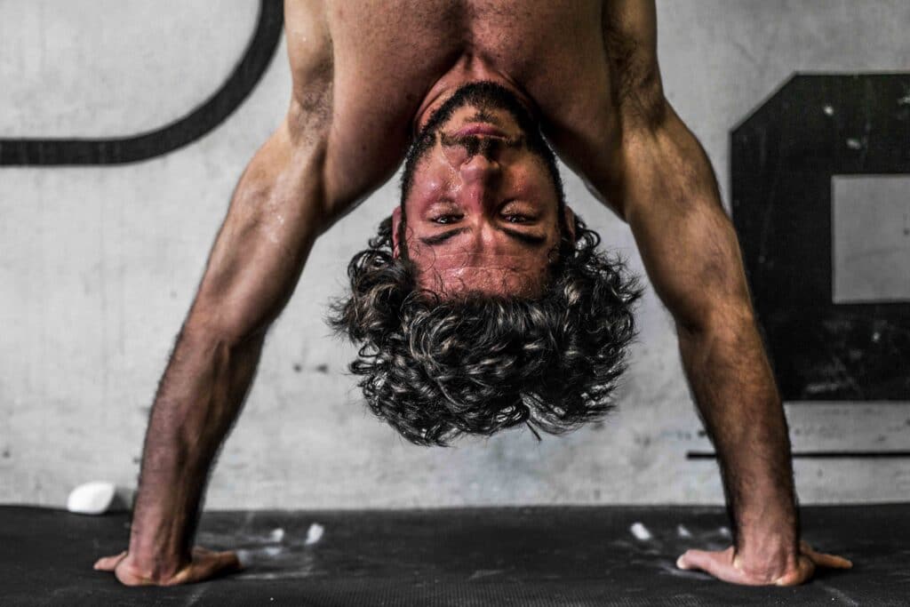 man performing handstand push ups