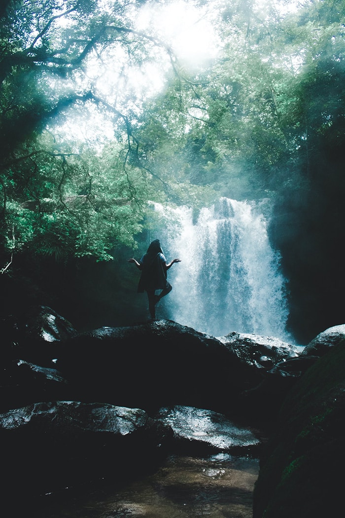 Man next to waterfall