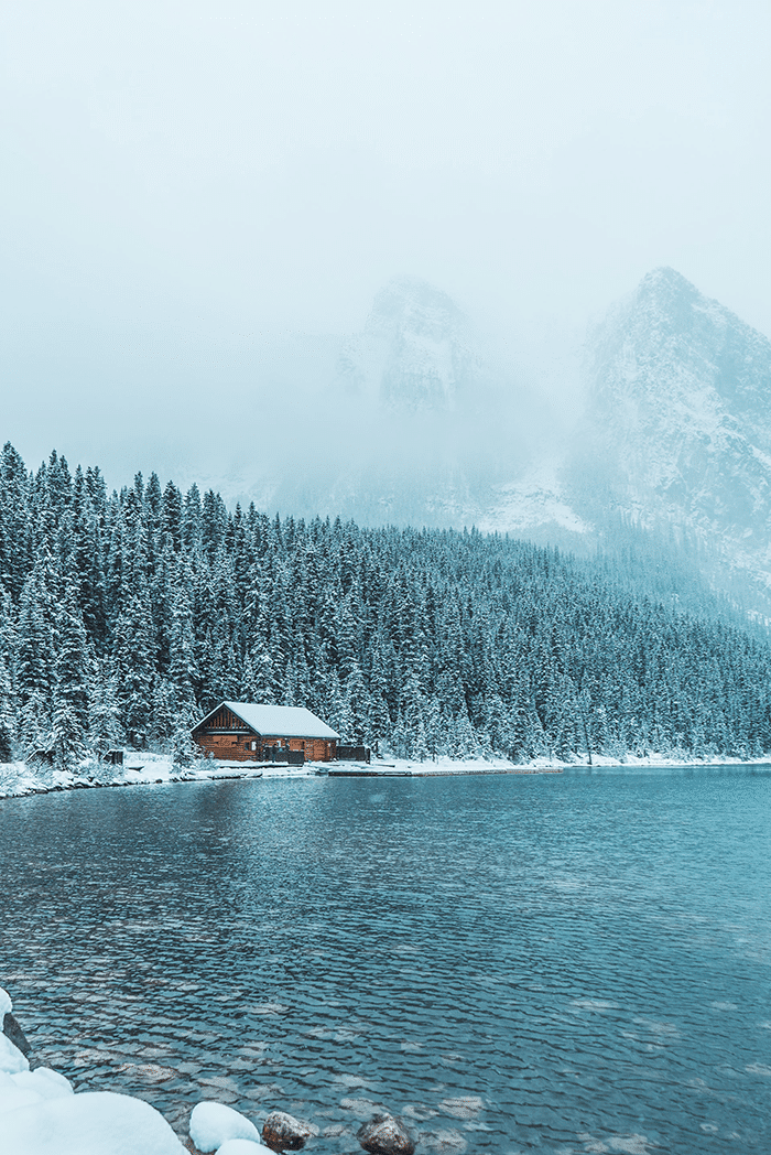 Cabin in snow by lake