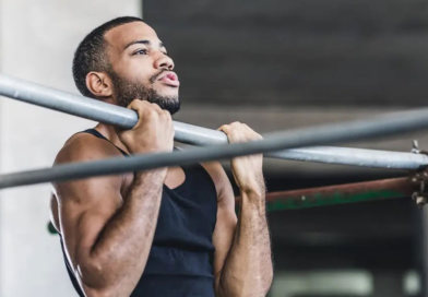 Male athlete performs chin up