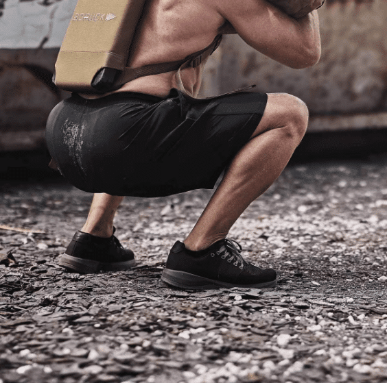 Man Squatting outside during workout