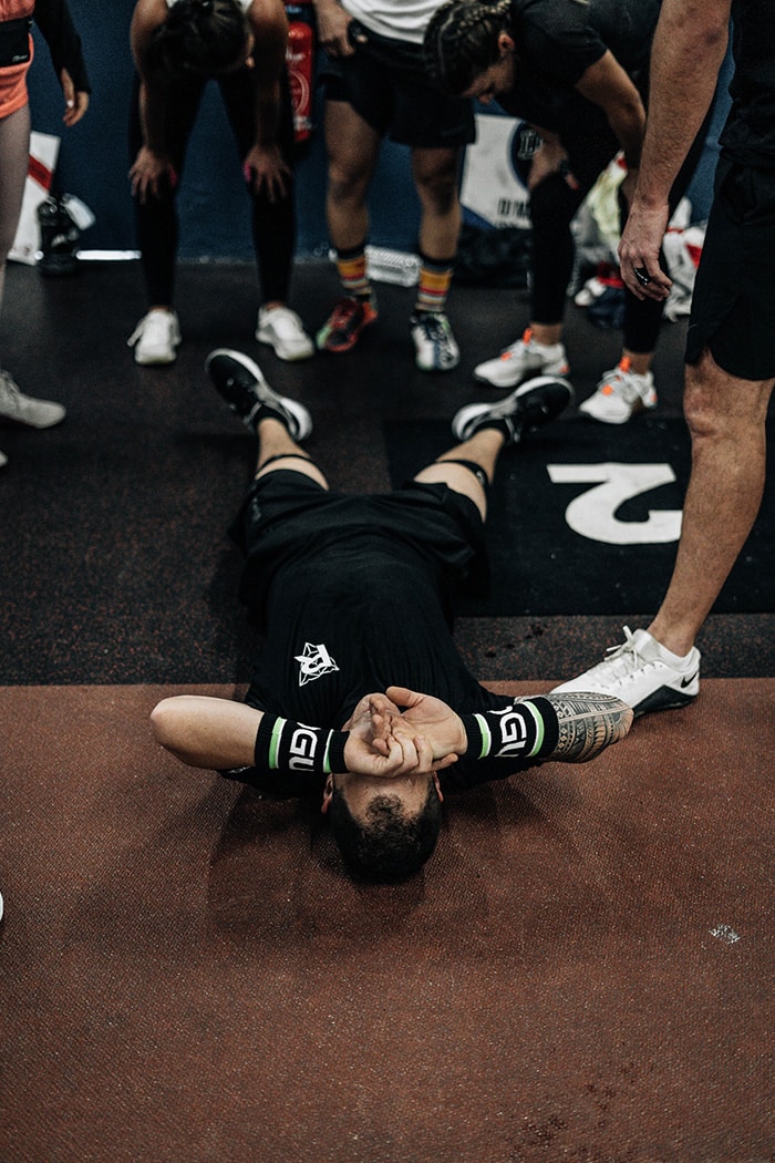 Man on floor after hanging knee raises