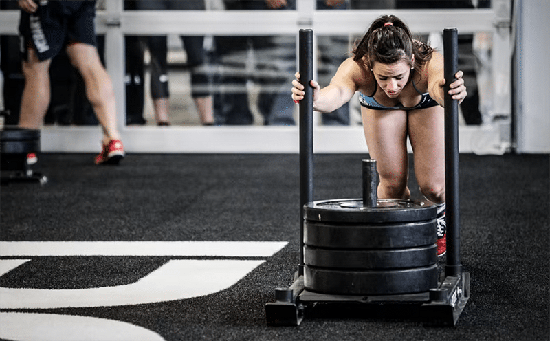 Woman during sled push workout