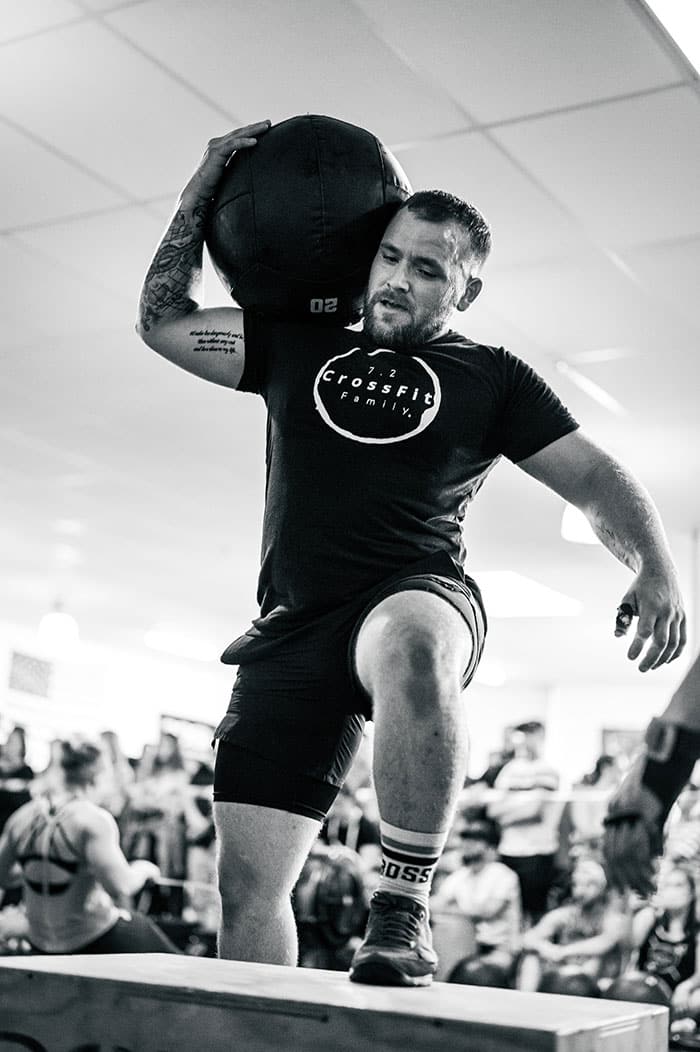 Man doing Sandbag step up on box