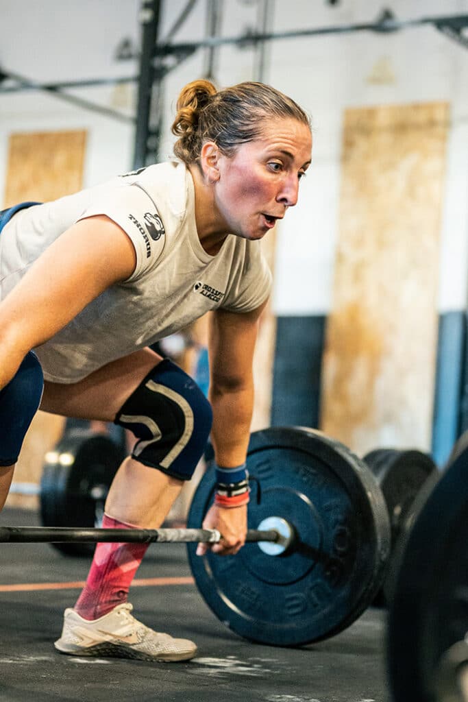 Woman snatching barbell
