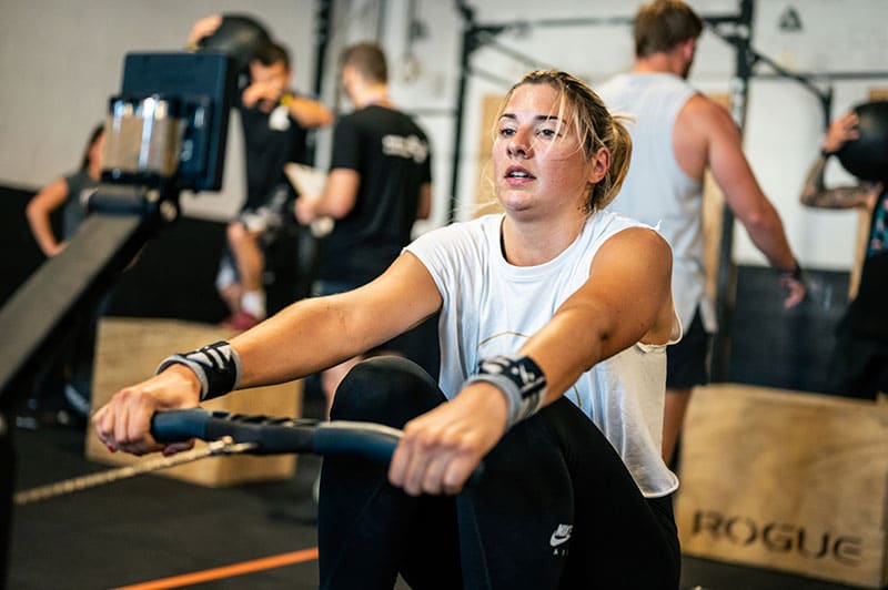 Woman in hard workout on rowing machine