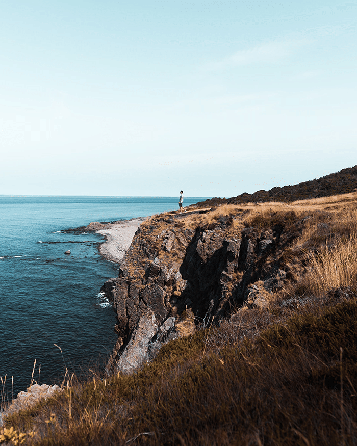 Man standing by the sea.