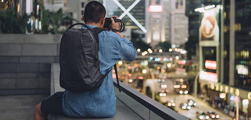 Man wearing an Able Carry Backpack