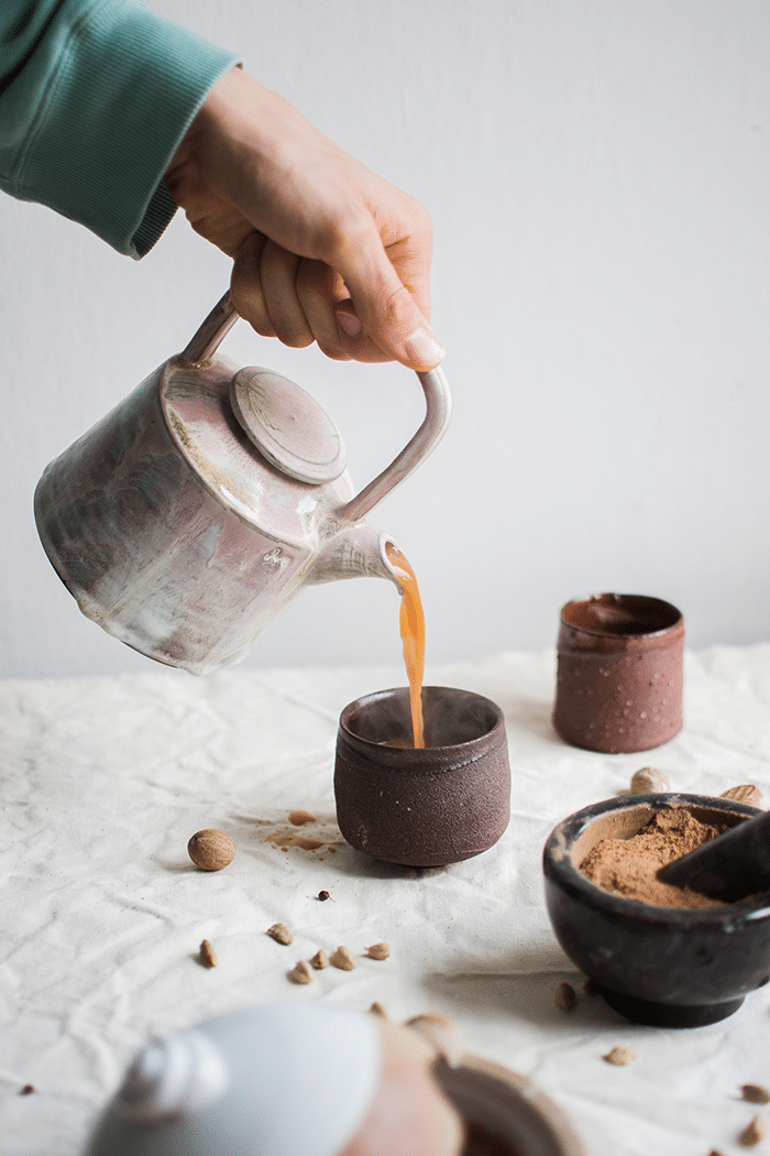 Pouring tea in rustic setting