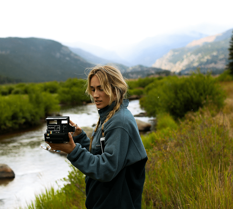 Woman with camera in nature