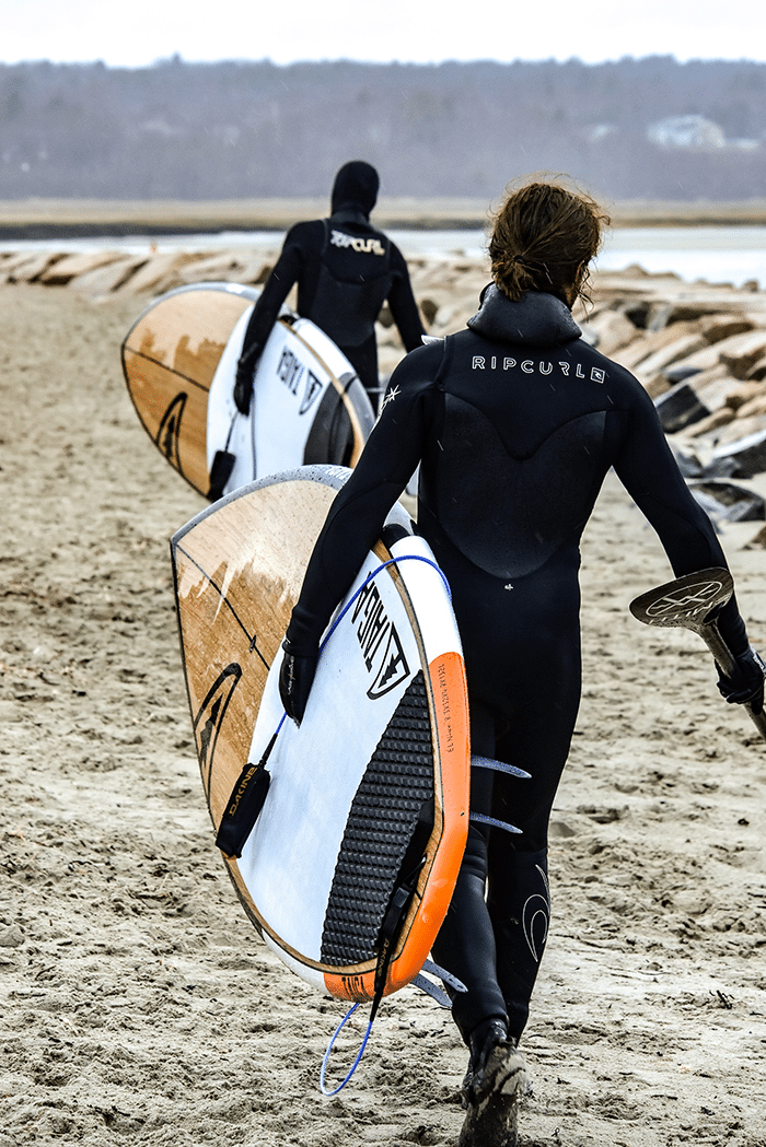 Men on beach with paddleboards