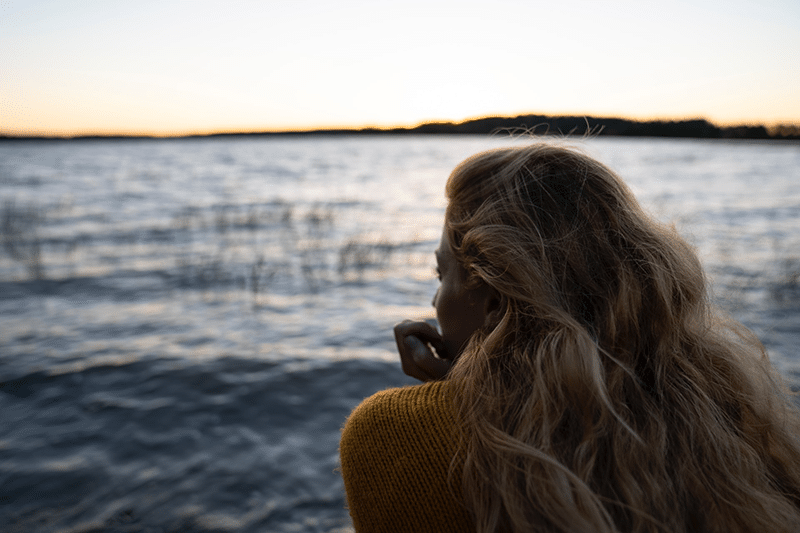 Woman looking out over the lake in Finland