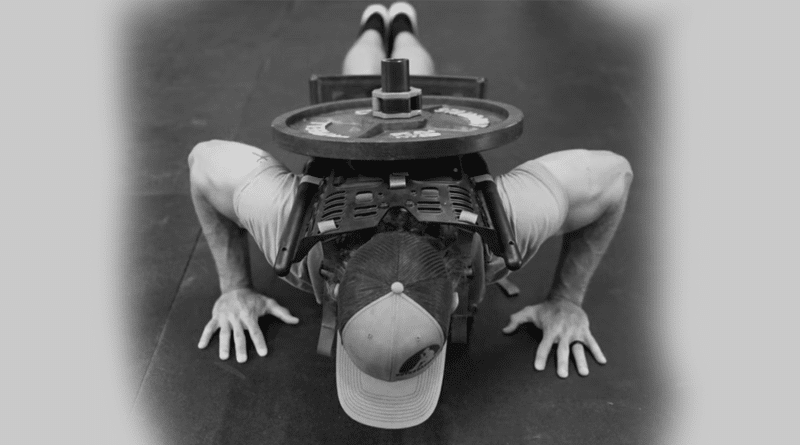 Man performing weighted push ups