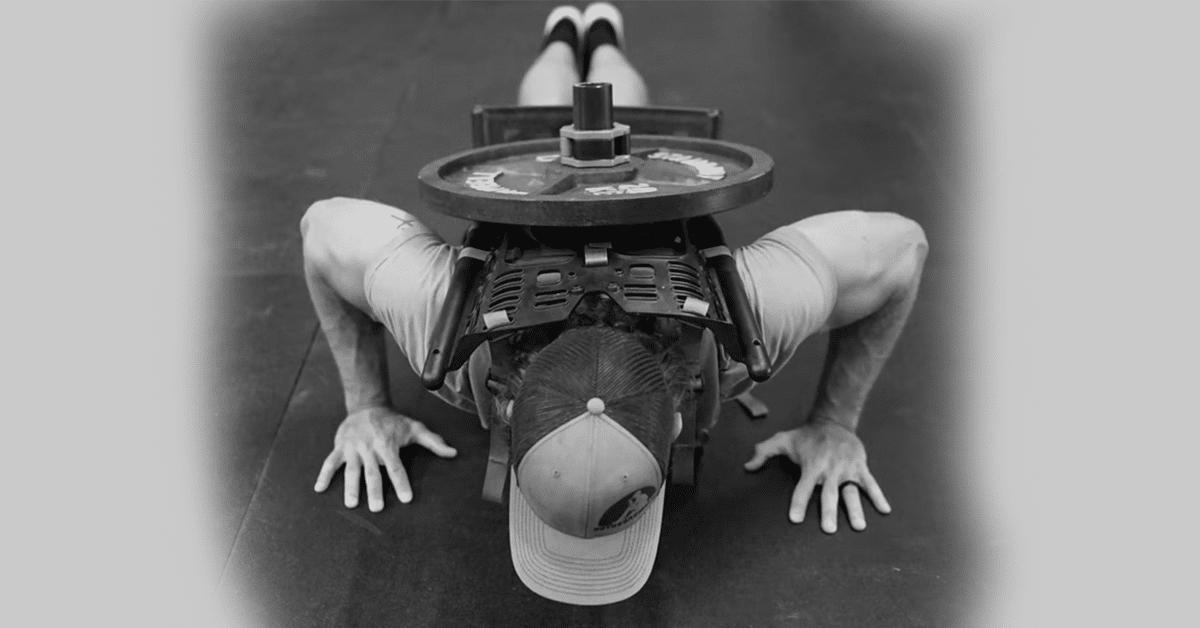 Man performing weighted push ups