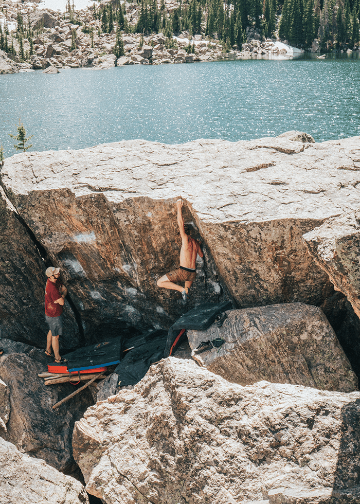 Man performing pull ups on rock