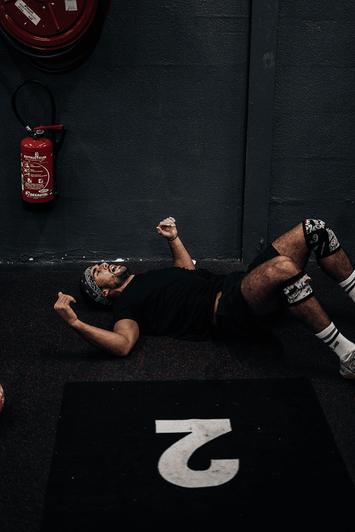 Tired man after barbell shrug