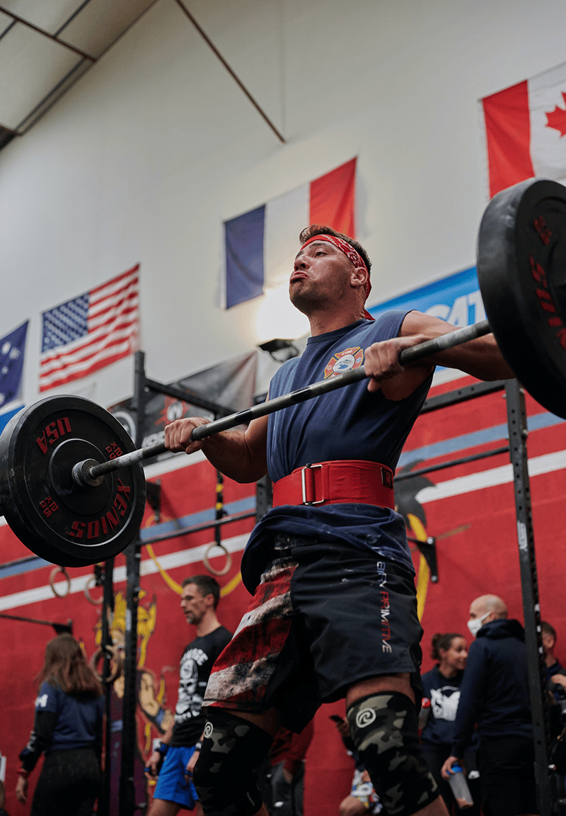 Man with barbell and headband.