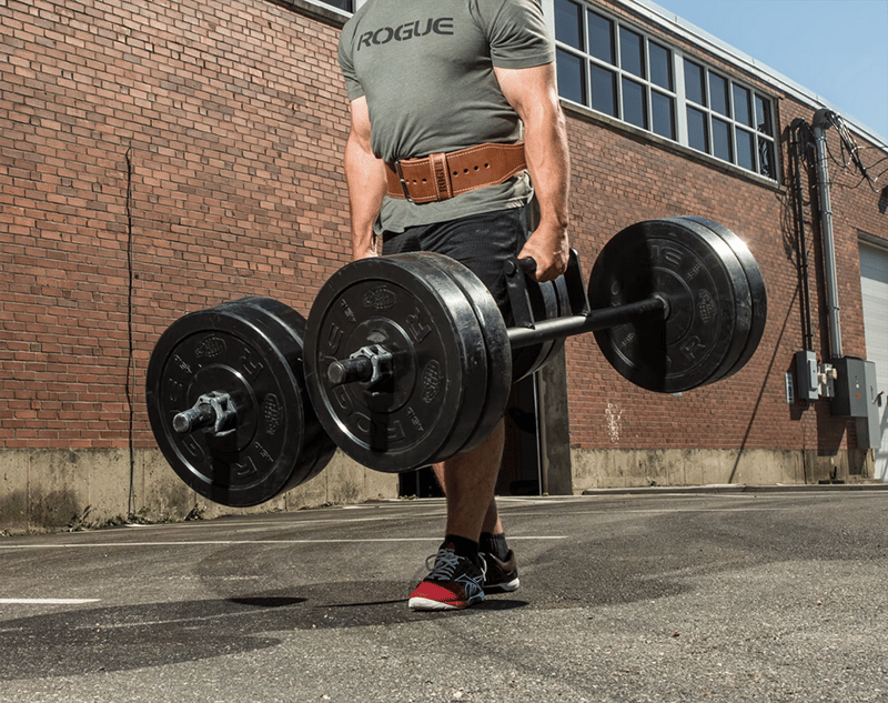 man carrying weights outside