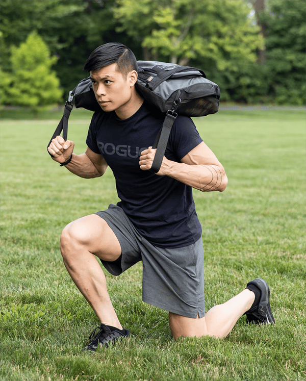Man lunging with Rogue 3 in 1 sandbag