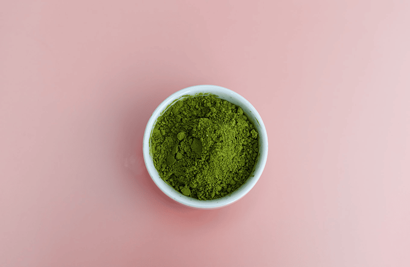 Matcha powder on pink background