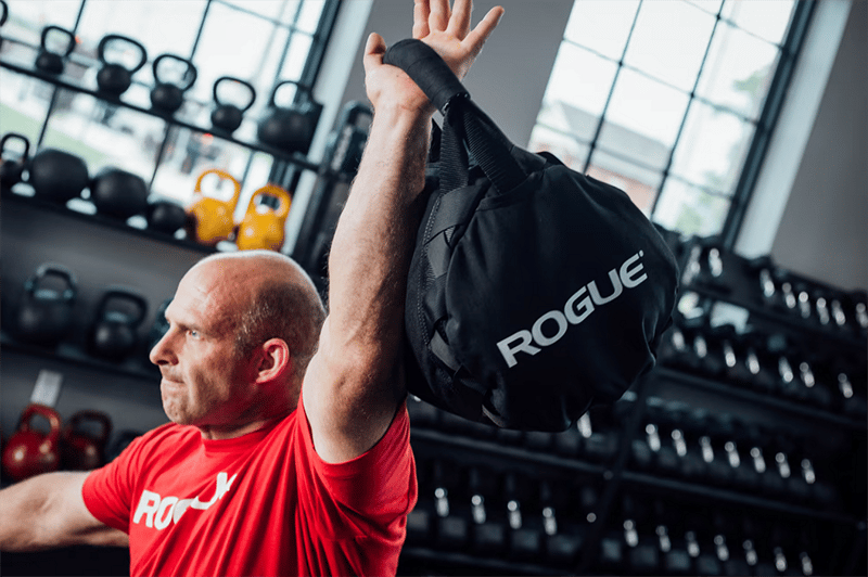 Male athlete with bag overhead