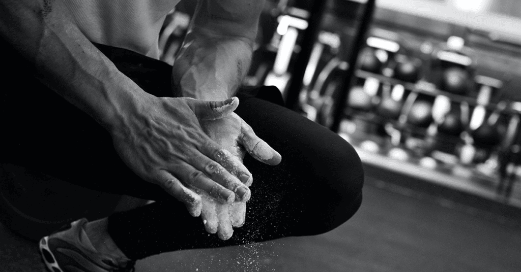 Athlete with chalk in the gym