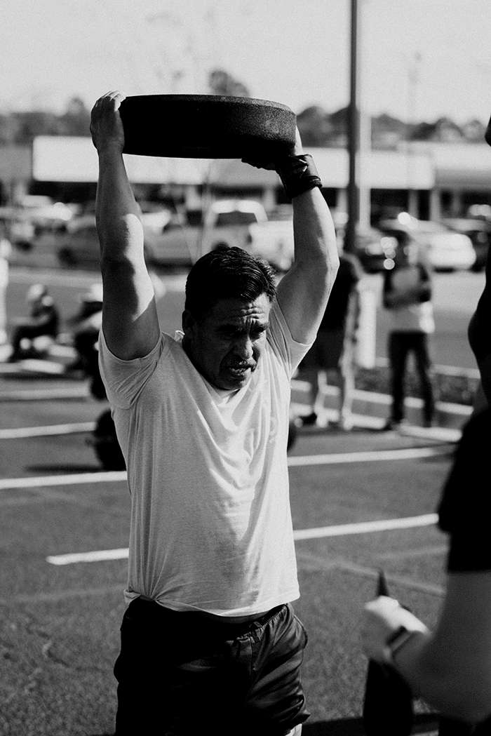 Man with weights plate overhead