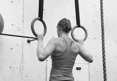 Woman doing pull ups on rings