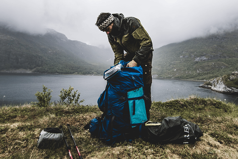Man packing best scandinavian tent brands after camping