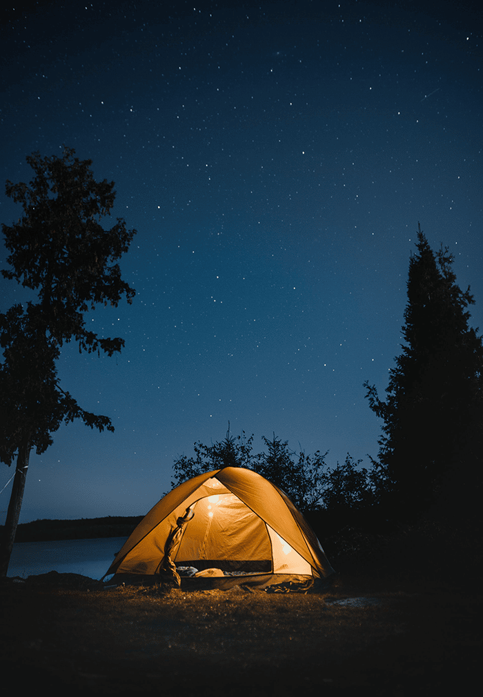 Tent at night with stars and trees