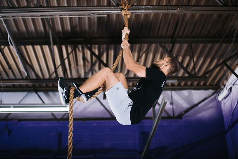 Man climbing rope