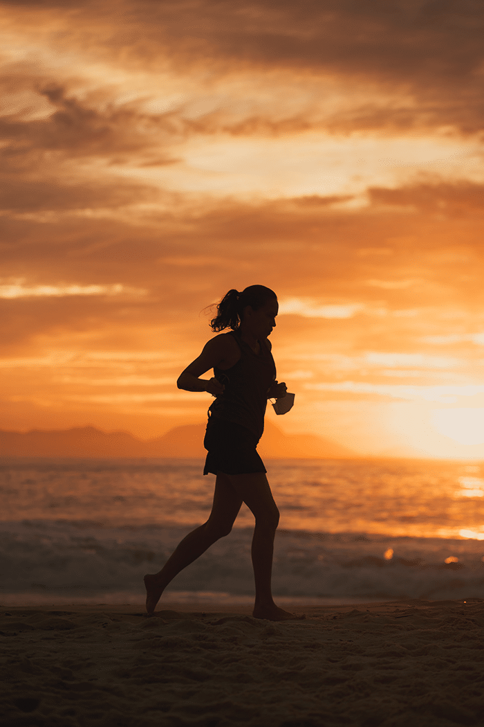 Woman running in sunset