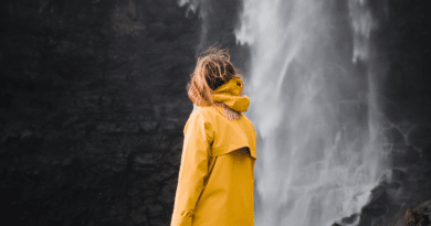 Woman next to waterfall