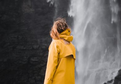 Woman next to waterfall