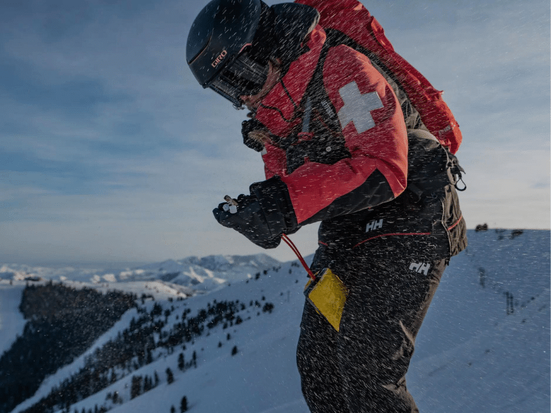 Man on mountain with Helly Hansen outdoor backpack