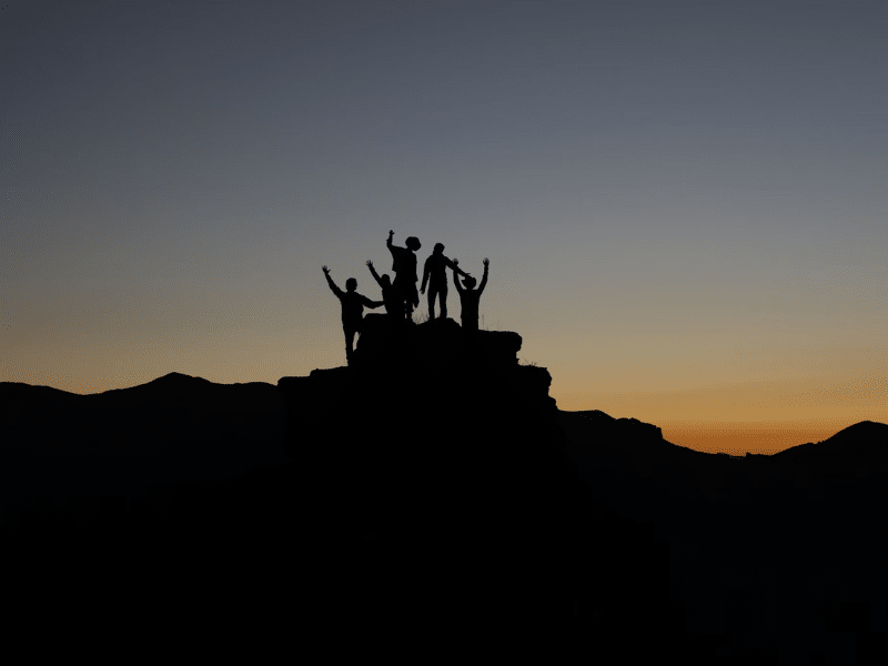 Kids on a hilltop at sunrise