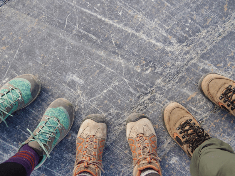 Three hikers compare walking shoes